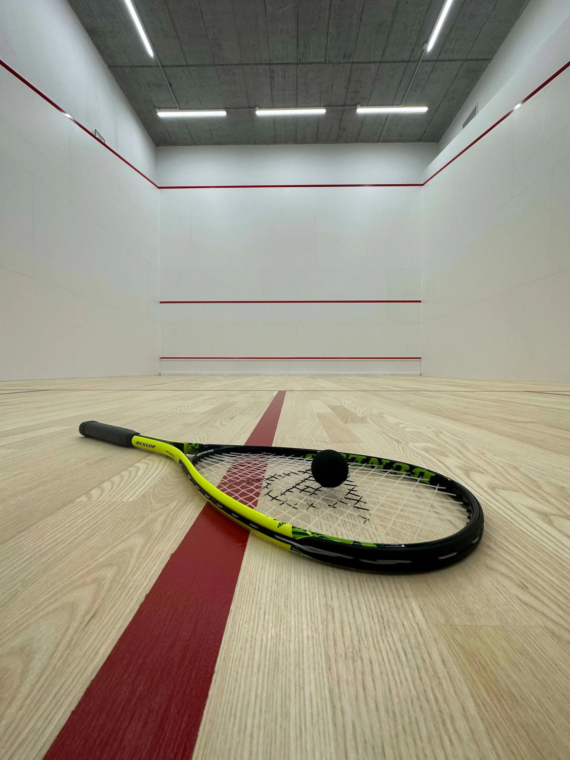 Racket and ball on the squash court